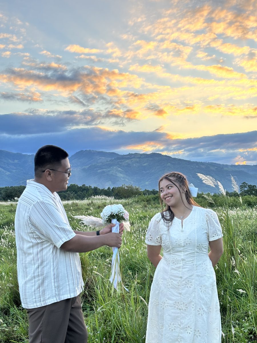 The couple facing each other in the field