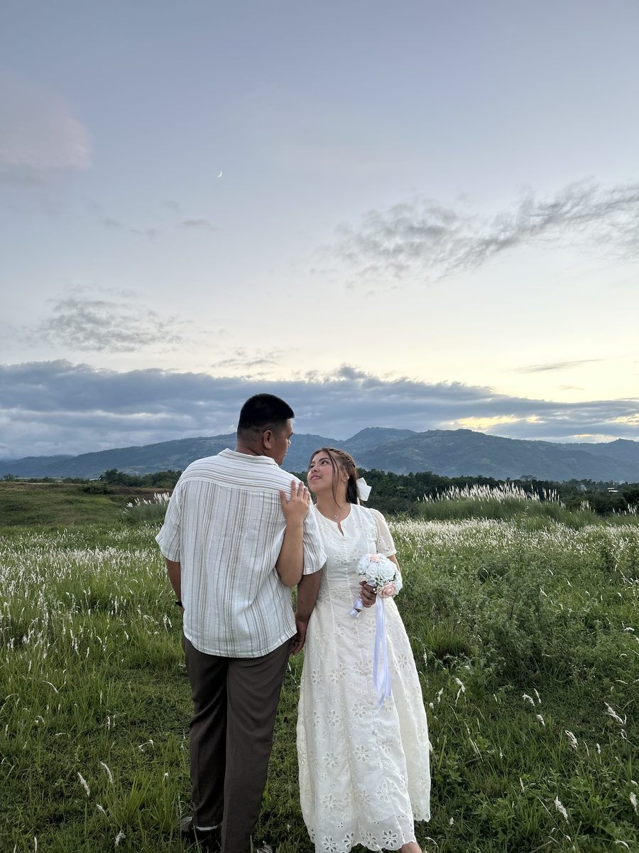 The couple looking up at the mountains